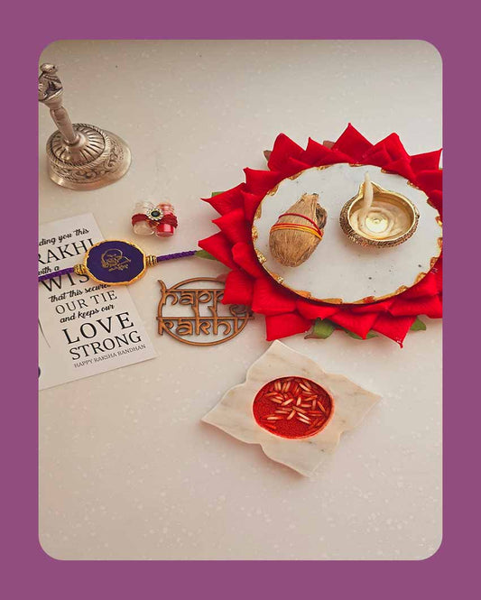 Purple Guru Ji Rakhi With Roli Chawal And Lotus Platter With Diya For Raksha Bandhan