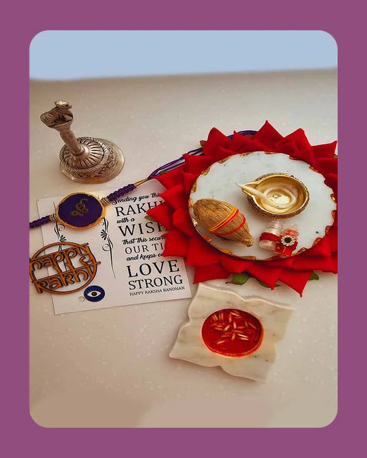 Purple Onkar Rakhi With Roli Chawal And Lotus Platter With Diya For Raksha Bandhan