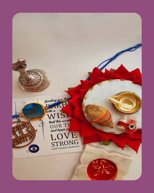 Turquroise Onkar Rakhi With Roli Chawal And Lotus Platter With Diya For Raksha Bandhan